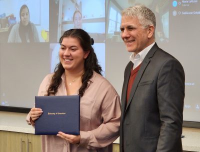 Alexandira Tomkunas receives certificate from Jeffrey Shoulson