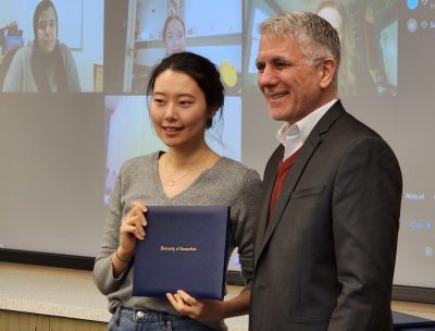 Minjung Choi receives certificate from Jeffrey Shoulson